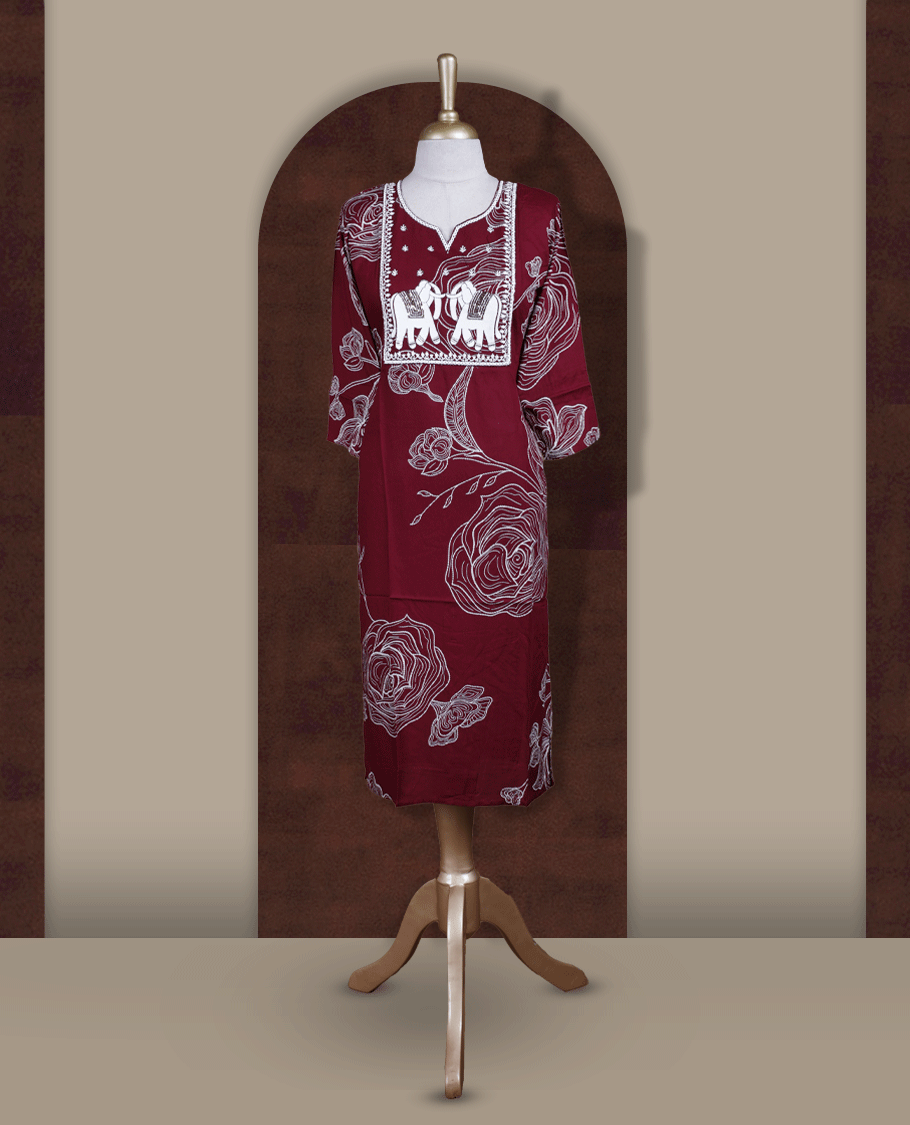 Maroon colour kurti featuring a square embroidered neck design with elephant motif patchwork, V-cut neckline, 3/4th sleeves, and floral printed body.