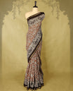Brown colour chanderi cotton saree with white floral Kodi printed body, Black border with peacock and floral motifs, grand pallu featuring large peacock designs, with matching blouse