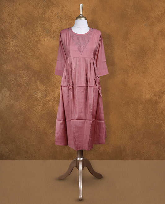 Coral pink colour kurti highlighted with delicate cutwork detailing along the scoop neckline, styled with gathered waist and comfy 3/4th sleeves.