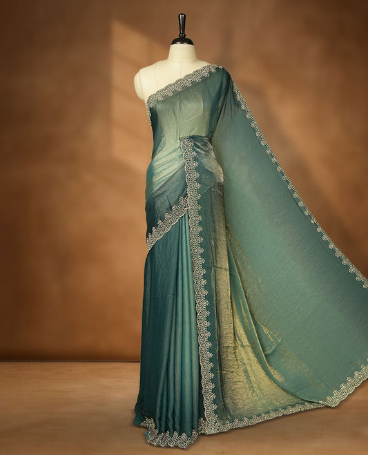 Teal blue with gold  colour shimmer fancy saree adorned body, paired with a with delicate gold stone worked border, with matching blouse