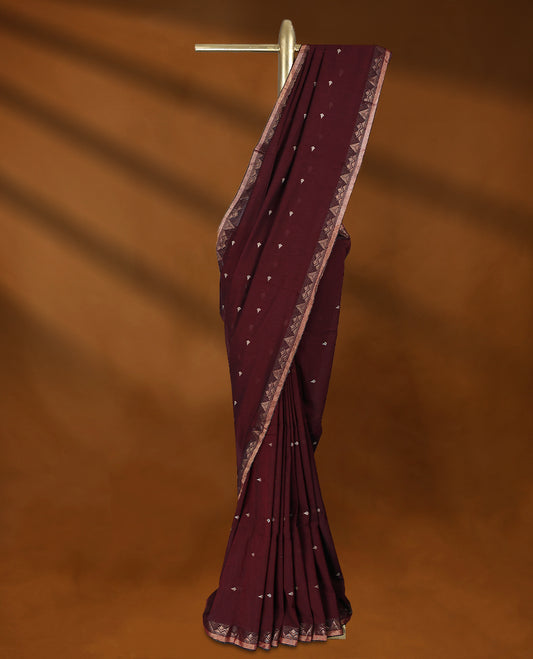 Dark Maroon colour soft khadi cotton saree with small Beige Zari motifs on the body, detailed woven Gold zari border, paired pallu with tussles, with matching blouse.