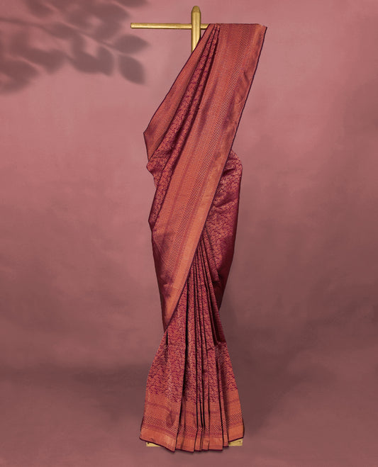 Maroon colour Kancheepuram saree featuring an antique zari brocade body, complemented by a traditional border and a matching blouse.