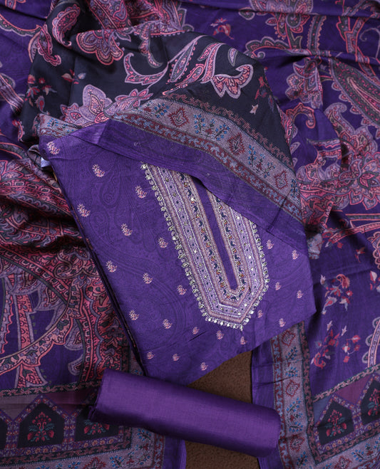 Dark lavender colour churidhar material featuring intricate paisley prints and delicate embroidery, paired with a plain matching bottom and a printed dupatta.