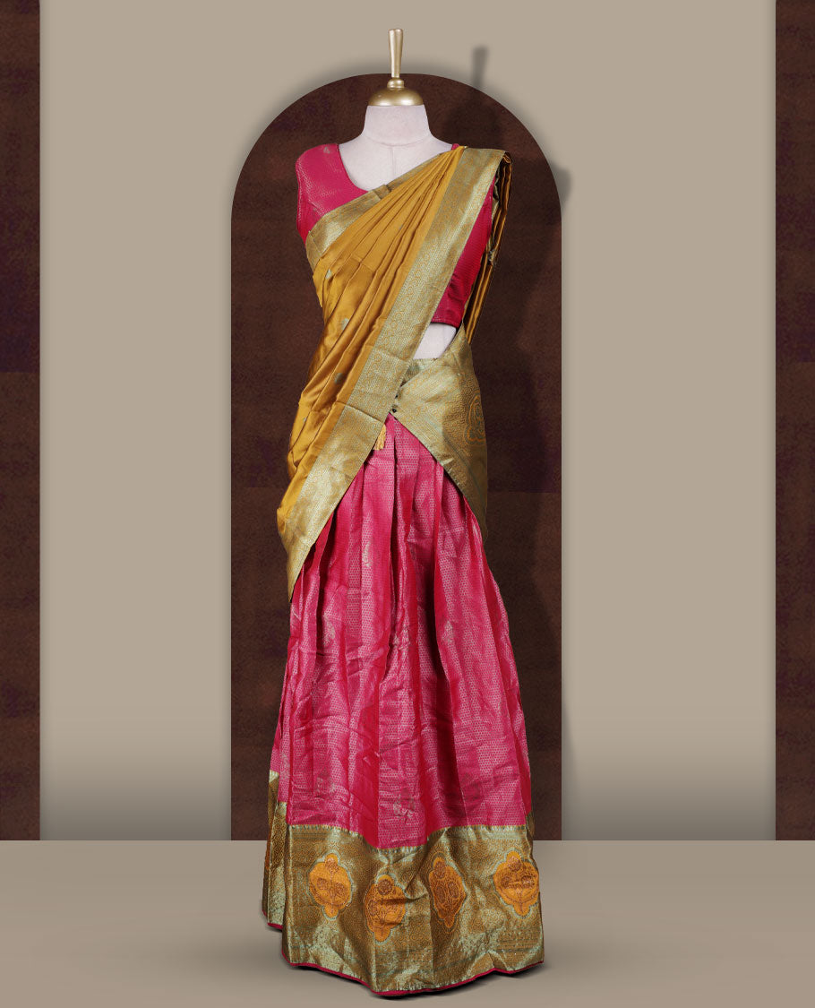 Rani Pink and mustard colour Dhavani set featuring a Rani pink colour skirt with contrast Mustard colour border with rich silver zari pattern, paired with a contrasting Mustard dupatta detailed with silver motifs