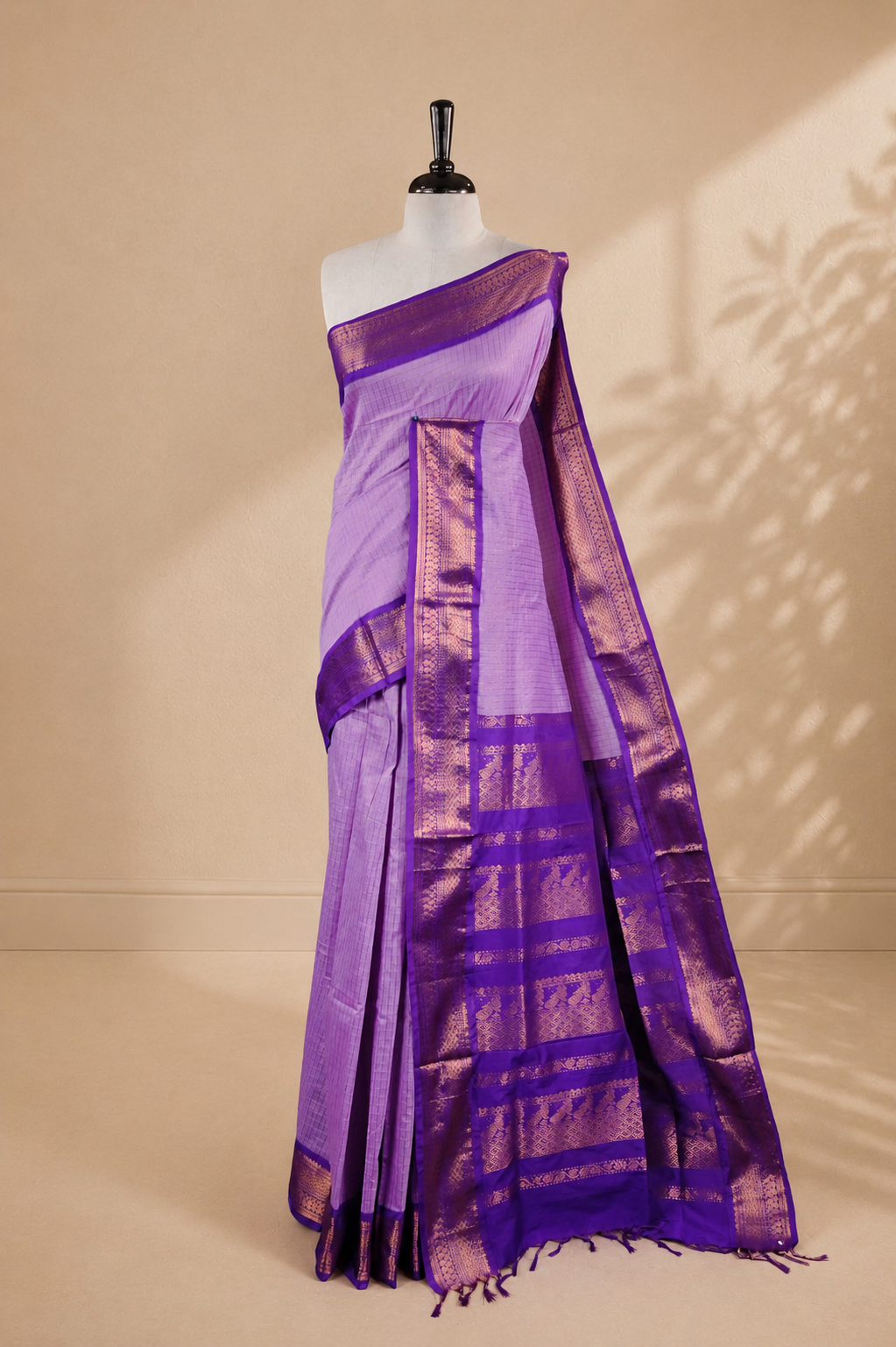 Lavender colour kalyani cotton saree featuring gold zari check pattern on body, complemented by Violet colour with Antique zari border, paired with matching blouse piece.