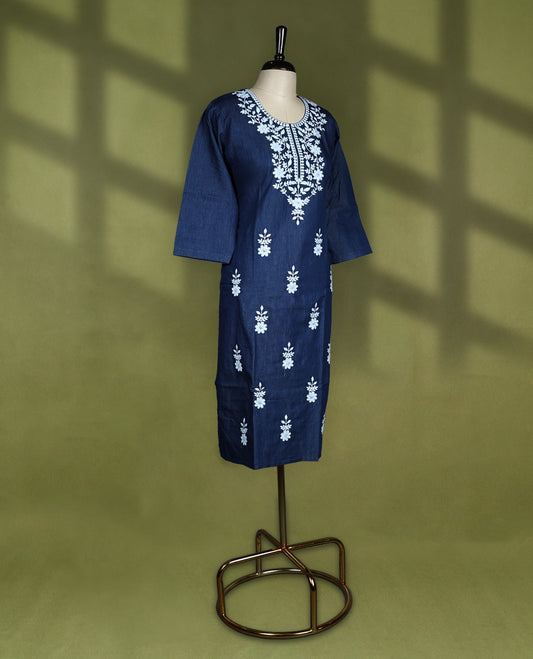 Deep navy blue colour kurti featuring intricate white floral thread embroidery on the yoke and all over the front panel, designed with a rounded neckline and keyhole detail, paired with 3/4th sleeves and straight hemline