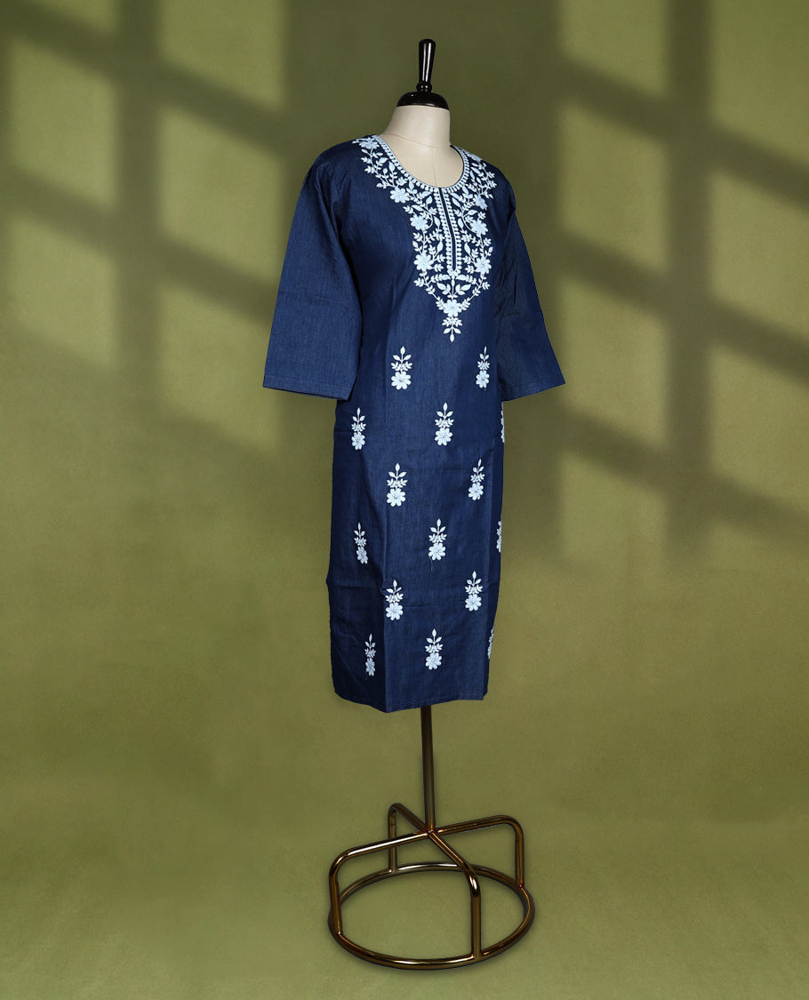Deep navy blue colour kurti featuring intricate white floral thread embroidery on the yoke and all over the front panel, designed with a rounded neckline and keyhole detail, paired with 3/4th sleeves and straight hemline