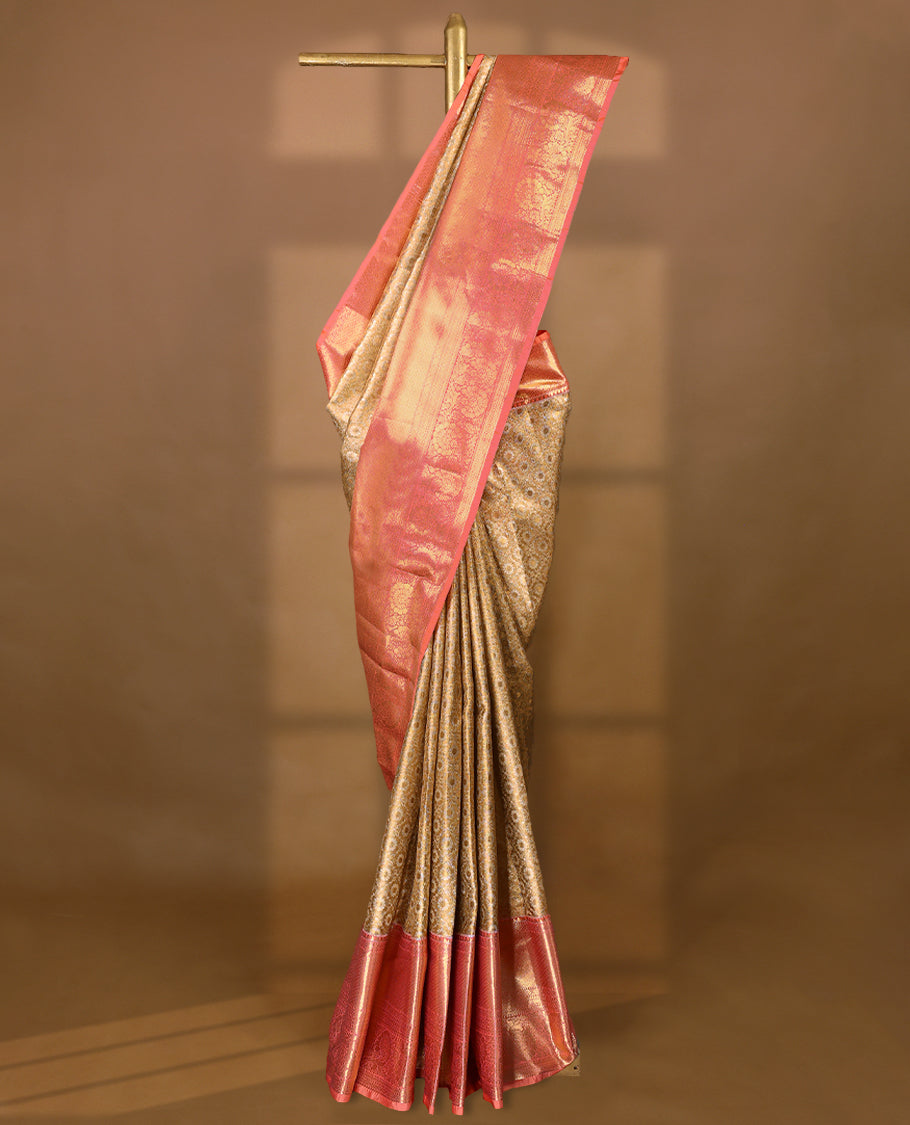 Gold colour tissue brocade saree with gold and silver zari floral & Geometric pattern on body, gold zari traditional floral and peacock work Peach border, rich matching pallu with Antique zari motifs, paired with matching blouse.