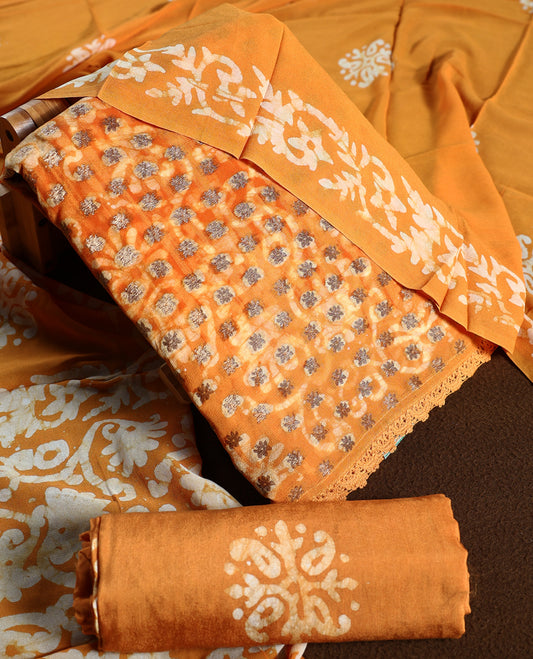 Deep yellow colour churidhar material featuring delicate floral patterns with gold highlights and bold block designs, paired with a plain matching bottom and a dupatta featuring bold white floral block prints.