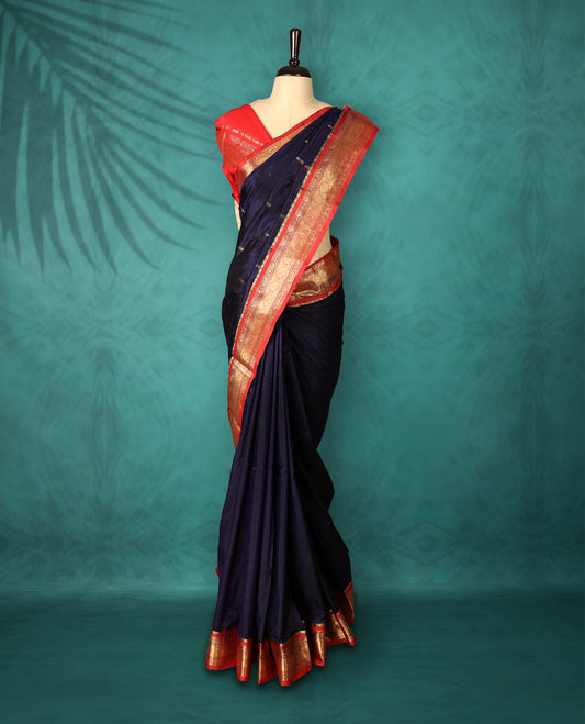 Navy Blue colour Traditional Kancheepuram Silk saree with small gold motifs on body, Deep Red traditional border with intricate gold zari weaving, grand zari pallu, perfect for Bharatanatyam, with matching blouse.