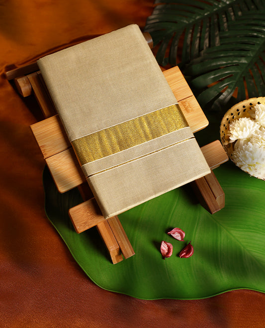 Golden beige pure handloom double dhoti featuring a broad shimmering golden zari border, crafted in a rich and elegant finish, perfect for weddings, festive wear, and traditional occasions.