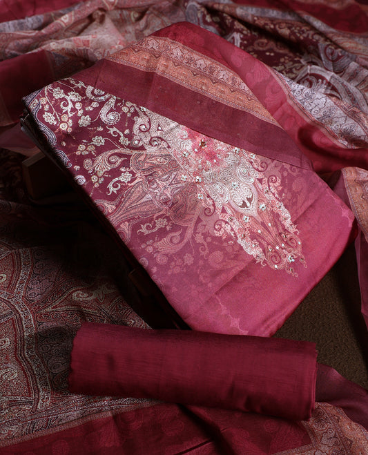 Rich maroon colour churidhar material adorned with elegant embroidery and intricate paisley patterns, complemented by a beautifully printed dupatta and plain bottom.
