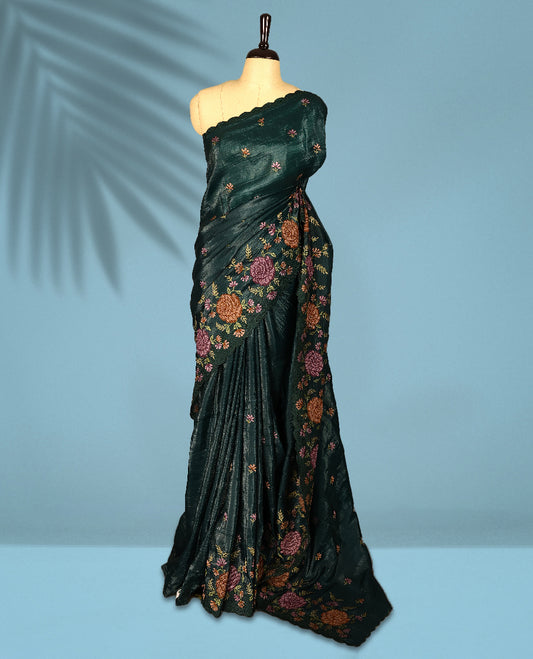 Deep Sea Green Colour crush soft silk saree, textured body with a natural crinkled finish, adorned with intricate Multi colored floral Motifs and complemented by a delicate Multi Colour Bold Floral embroidery border, paired with a matching blouse