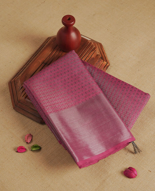 Dusty pink colour semi silk saree featuring neem zari Brocade geometric Pattern all over the body, complemented by a Self Colour woven border with detailing, Pallu & blouse.