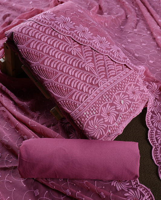 Graceful mauve pink churidhar material featuring rich floral embroidery with sequin accents, paired with a plain matching bottom and intricately embroidered dupatta, making it perfect for festive and elegant occasions.