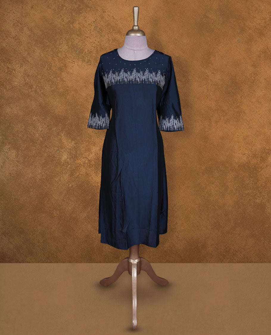 Navy blue colour kurti by Talisha with round neckline, delicate silver floral yoke embroidery and scattered motifs, A‑line calf‑length silhouette, and elbow‑length sleeves with embroidered cuffs.