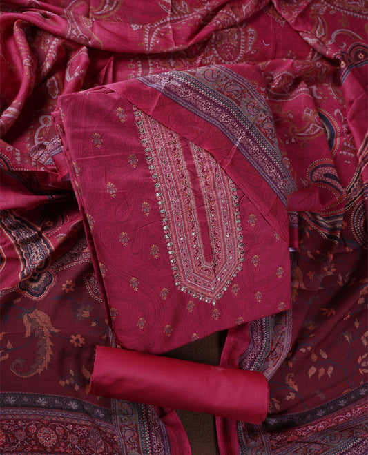 Medium maroon colour churidhar material featuring intricate paisley prints and delicate embroidery with stone highlights, paired with a plain matching bottom and a printed dupatta.