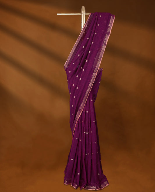 Magenta colour soft khadi cotton saree with small Beige Zari Flower motifs on the body, detailed woven Gold zari border, paired pallu with tussles, with matching blouse.
