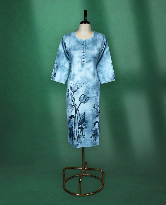 Light blue cotton kurti featuring a serene watercolour floral design near the hem and sleeves, complemented by a round neckline with vertical embroidery detail and three quarter sleeves, graceful pick for a relaxed yet refined look.
