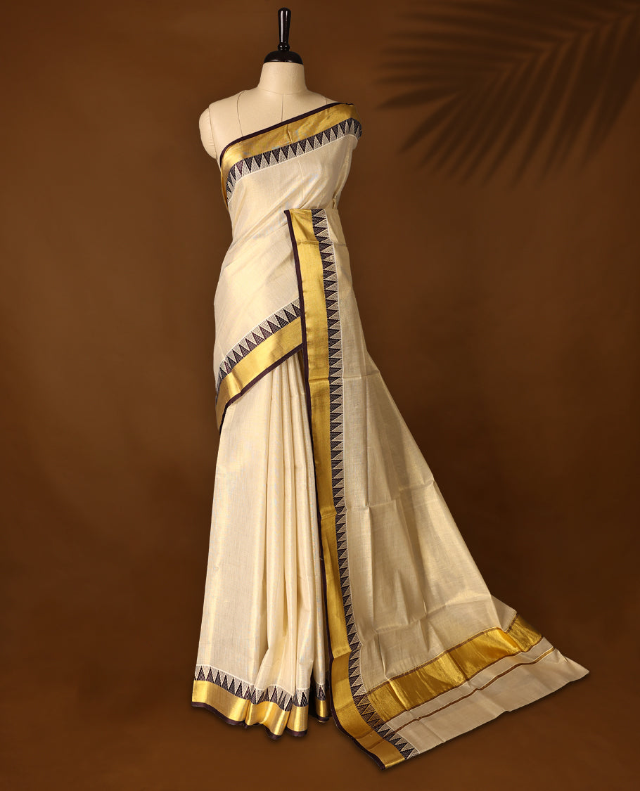 Elegant Light Gold colour Tissue Kerala saree featuring Plain body and traditional golden zari kasavu border with chocolate colour temple work offering a classic and graceful look, paired with a matching blouse.