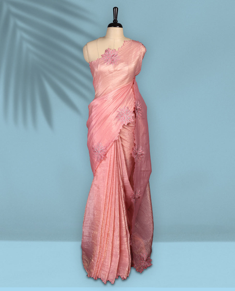Peach colour crush soft silk saree adorned with bold floral thread embroidery on the body and scallop edged borders, Paired with a matching blouse for a complete look.