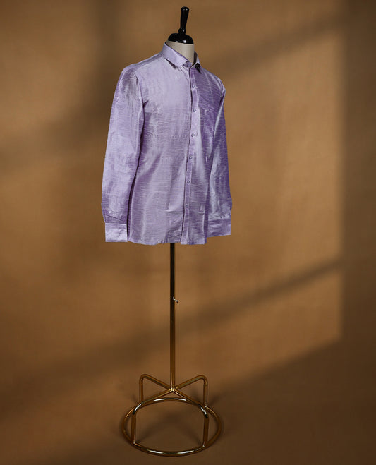 Lavender lilac colour DH men’s shirt in a relaxed formal fit featuring a lustrous semi silk finish, full sleeves, classic collar, and chest pocket ideal for festive and traditional occasions.