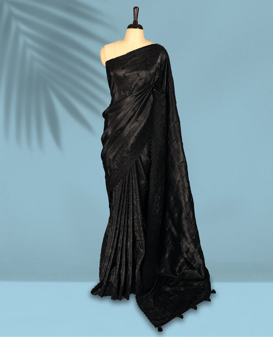 Black Colour crush soft silk saree, textured body with a natural crinkled finish, adorned with intricate self colored floral Motifs  and complemented by a delicate thread embroidery cutwork border, paired with a matching blouse