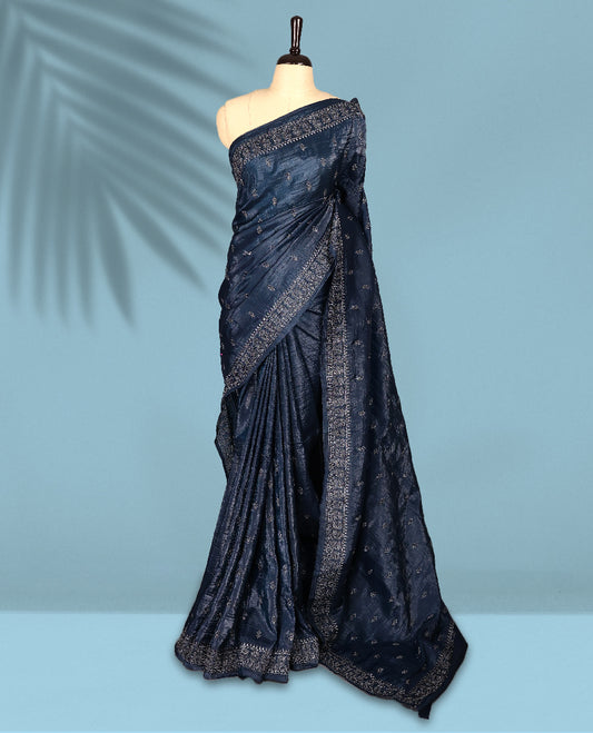 Midnight Blue Colour crush soft silk saree, textured body with a natural crinkled finish, adorned with Silver colored floral Motifs and complemented by a delicate Silver Zari embroidery border, paired with a matching blouse