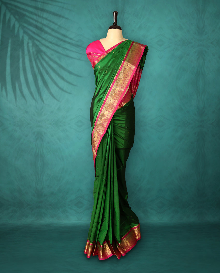 Deep Green colour Dharmavaram saree with small gold motifs on body, Magenta traditional border with intricate gold zari weaving, grand zari pallu, perfect for Bharatanatyam, with matching blouse.
