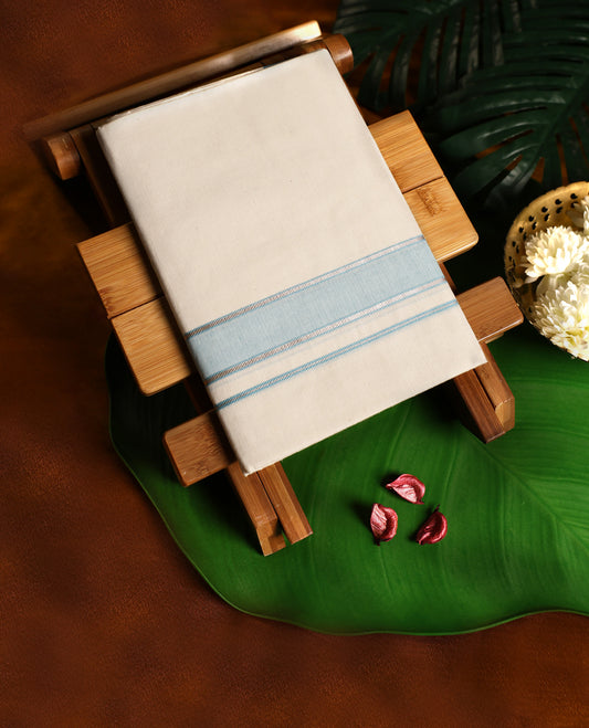 Off white cotton single dhoti featuring a sky blue kara with fine double line edging, crafted for traditional elegance and daily comfort, perfect for rituals, temple visits, and cultural occasions.