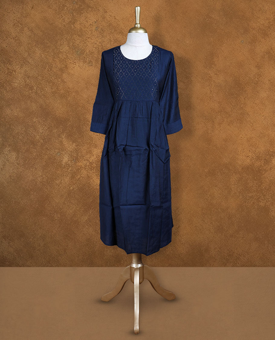 Navy blue colour kurti highlighted with a diamond-patterned cutwork yoke, styled with a scoop neckline, gathered waist and comfy 3/4th sleeves.