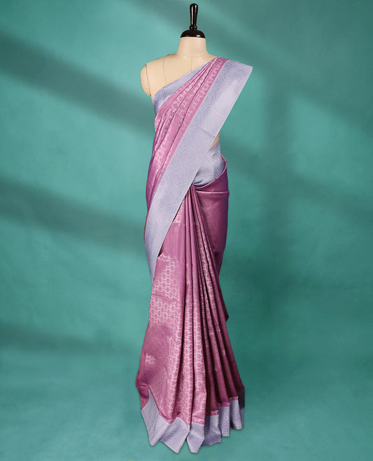 Pink coloured semi silk saree featuring a Zari design on the body, paired with a Baby Blue coloured border and matching blouse.