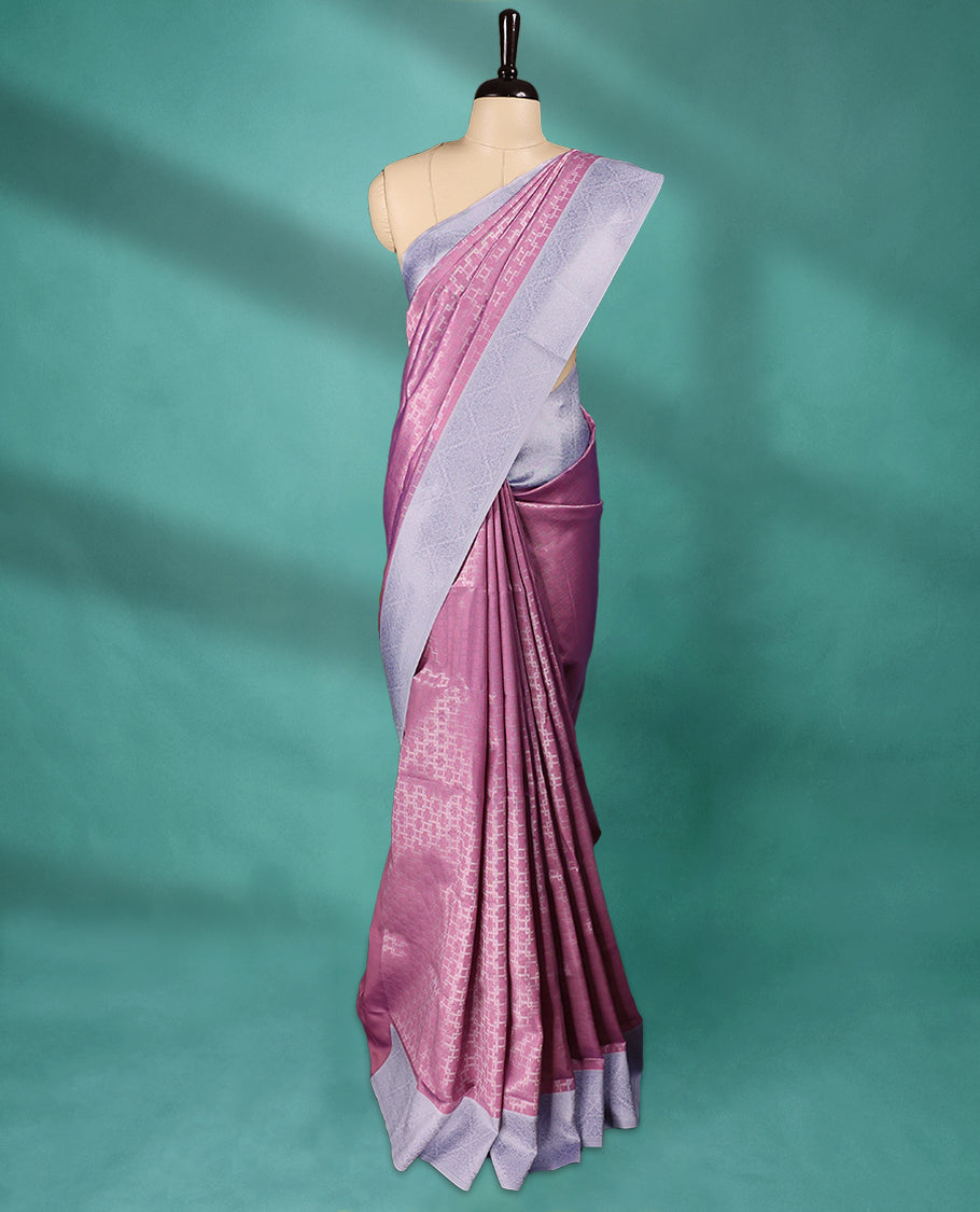 Pink coloured semi silk saree featuring a Zari design on the body, paired with a Baby Blue coloured border and matching blouse.