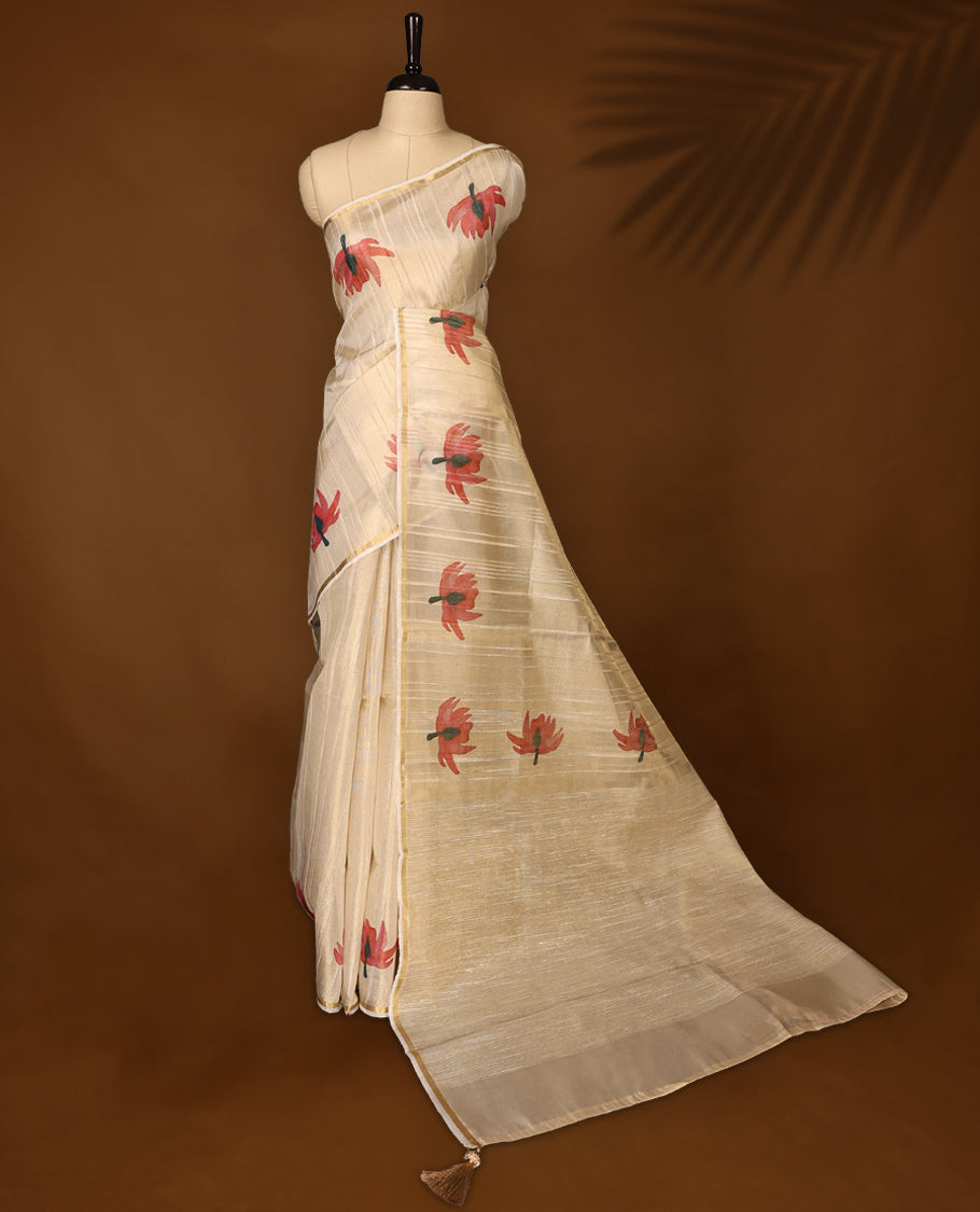 Elegant off white colour organza Kerala saree with golden sheen and floral prints, paired with a matching blouse, Features a flowy texture and tasselled pallu, Perfect for festive, casual, or semi-formal occasions.