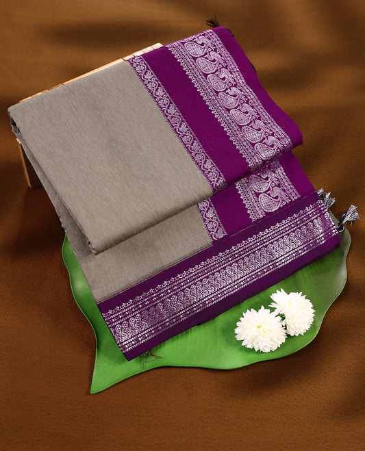 Grey colour mixed Kalyani cotton saree featuring Plain body, paired with a purple colour traditional border and pallu, with matching blouse