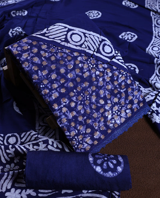 Navy blue colour churidhar material adorned with gold and copper toned floral patterns and bold block designs, paired with a plain matching bottom and stylish dupatta, perfect for festive evenings and traditional gatherings.