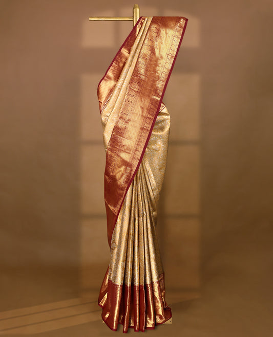 Gold colour tissue brocade saree with gold and silver zari kodi pattern on body, gold zari traditional pattern work Deep Maroon border, rich matching pallu with Antique zari motifs, paired with matching blouse.