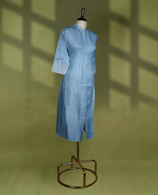Soothing sky blue colour kurti featuring a mandarin collar and three quarter sleeves, adorned with fine pintuck detailing and delicate embroidery on the cuffs.