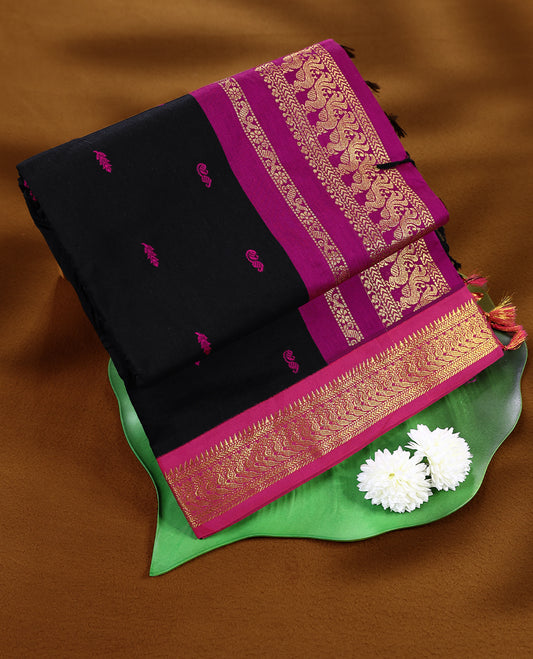 Pure Black colour mixed Kalyani cotton saree featuring Magenta zari motifs throughout the body, paired with a Magenta colour traditional border and pallu, with matching blouse