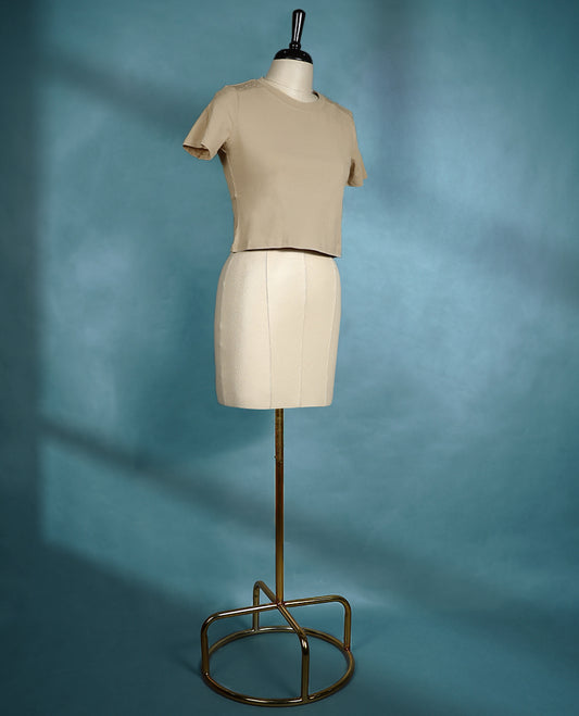 Beige colour fitted T shirt with short sleeves and subtle stud detailing on the shoulders, offering a clean and minimalistic look.