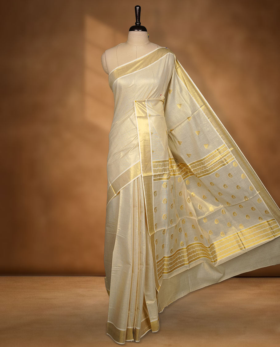 light gold tissue Kerala saree featuring delicate gold zari buttas across the body, a subtle kasavu border, and a finely woven traditional pallu, paired with a matching blouse