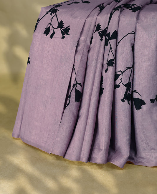 Pastel Purple colour semi printed saree featuring black florak kodi prints across the body, finished with a sleek plain border, with matching blouse