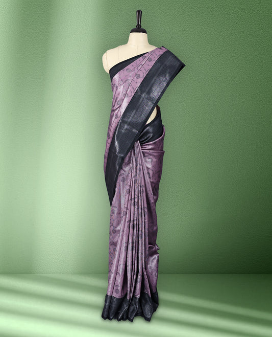 Light pastel onion colour semi silk saree featuring neem zari floral kodi motifs all over the body, complemented by a pure black woven border with geometric detailing, with matching blouse.