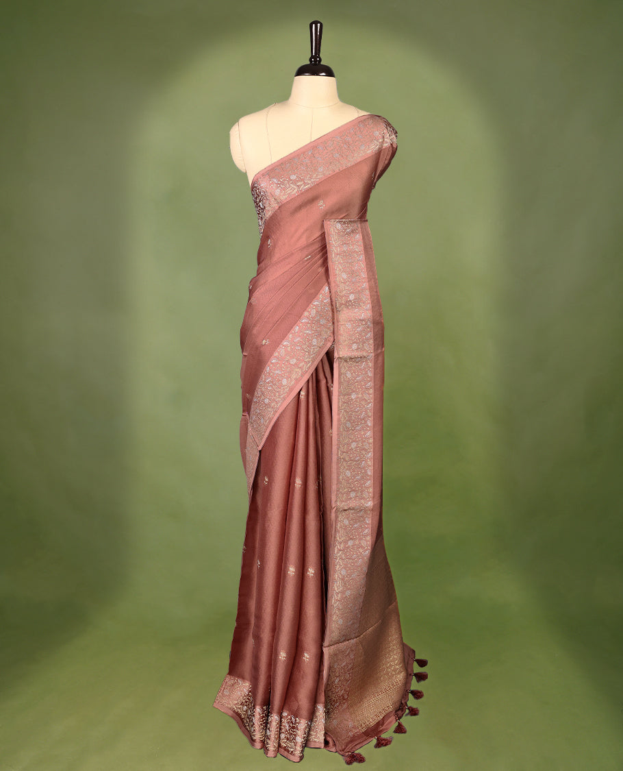 Pastel brown colour pure Banaras crepe saree showcases elegant Gold zari Flower Motifs all over the body, a traditional gold & Silver zari border, a rich intricately woven pallu, and comes with a matching blouse.