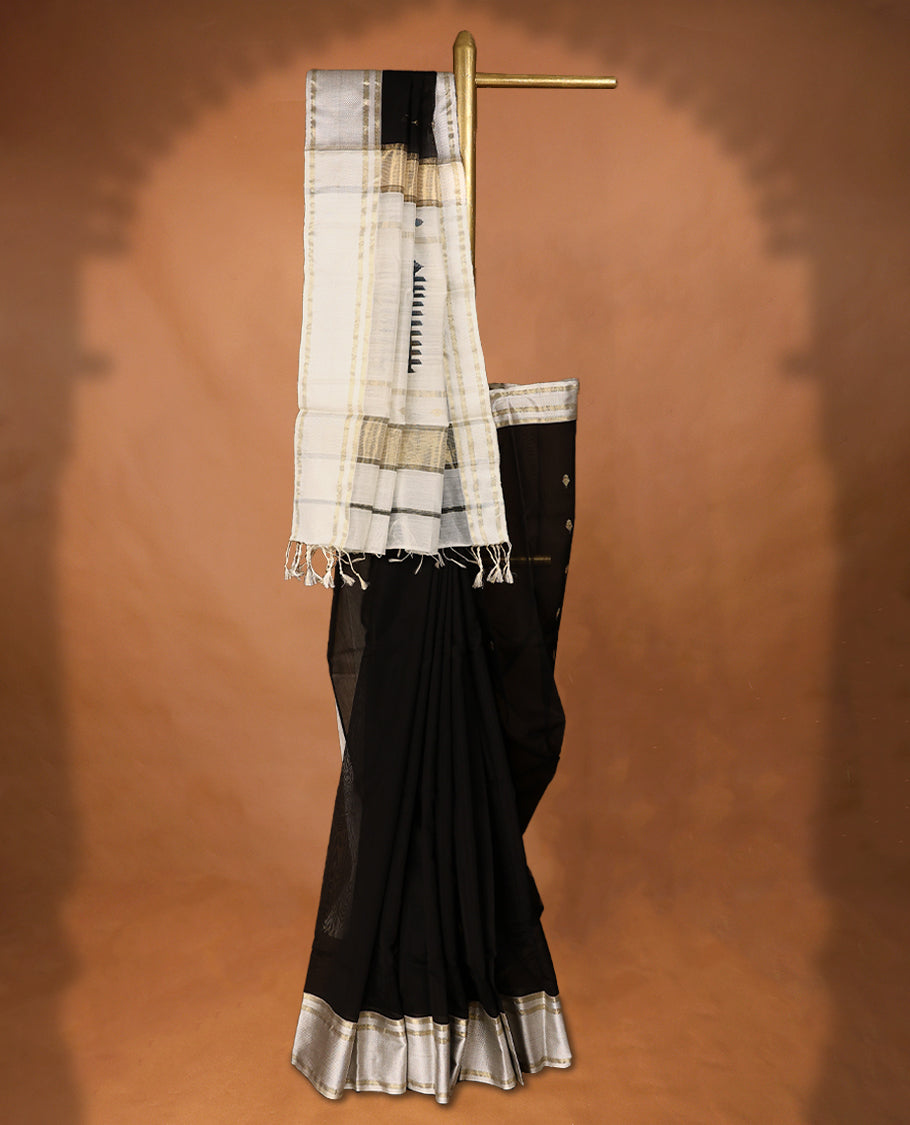 Pure Black coloured Maheshwari Cotton saree featuring  Antique Zari Leaf motifs across the entire body, complemented by a traditional White coloured border and a matching blouse.