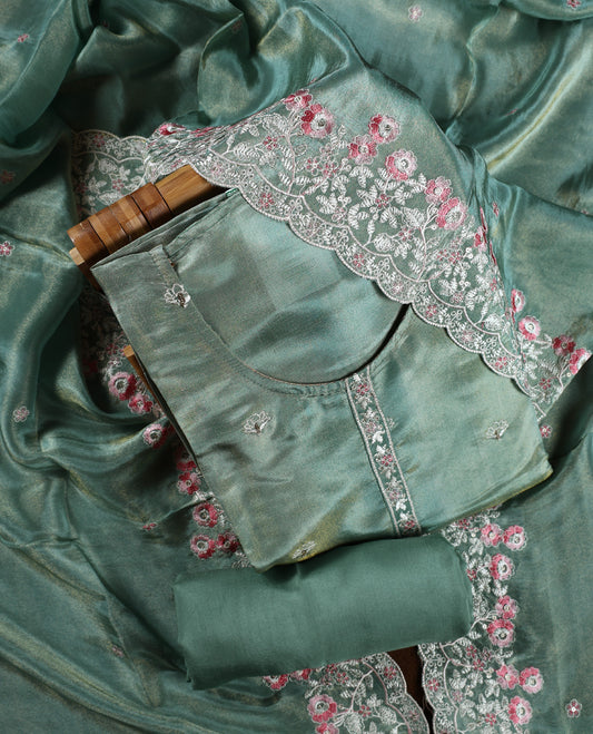 Sea green colour churidar material adorned with delicate floral thread embroidery in white and pink, paired with a plain matching bottom and embroidered dupatta, perfect for festive occasions and celebrations.