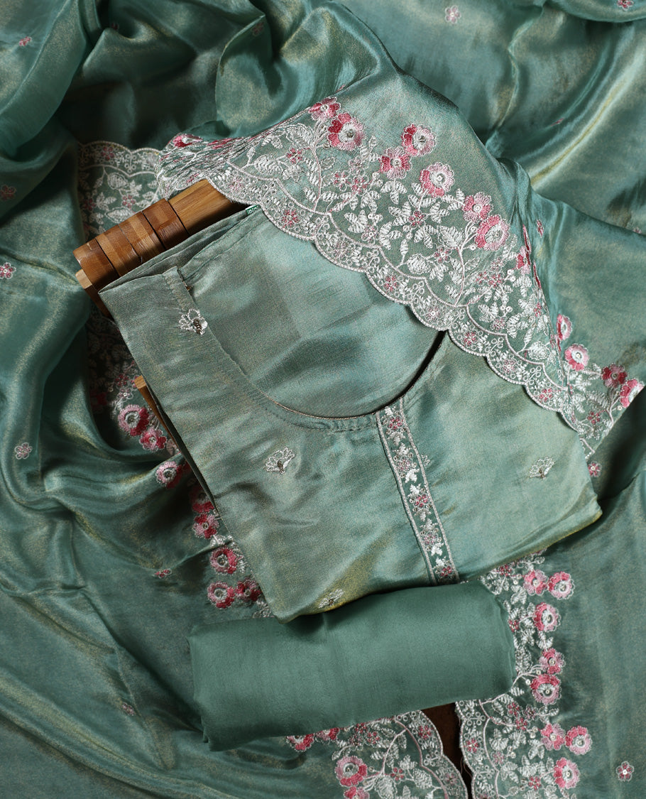 Sea green colour churidar material adorned with delicate floral thread embroidery in white and pink, paired with a plain matching bottom and embroidered dupatta, perfect for festive occasions and celebrations.
