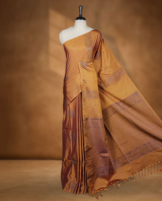 Mustard colour semi soft silk saree adorned with delicate woven floral kodi motifs on the body, complemented by a Self colour woven pallu with intricate detailing and tassel accents without border & Comes with a matching blouse piece.