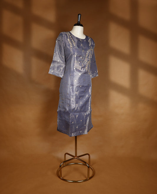 Ash blue colour tissue kurti from TWARA, featuring an intricate golden zari floral kodi pattern, finished with a round neckline and a button-down front placket.