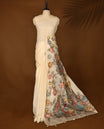 Elegant off white colour Kota net saree highlighted with vibrant hand painted motifs of peacocks and floral patterns on the pallu, blending tradition with artistic finesse & Perfect for festive and cultural occasions.